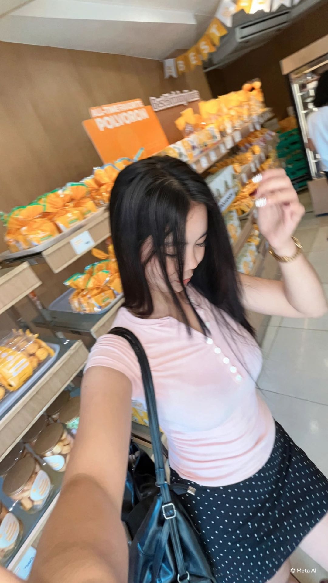 A woman from the Philippines taking a selfie in a bakery, the kind of girl you could meet in a meet chat